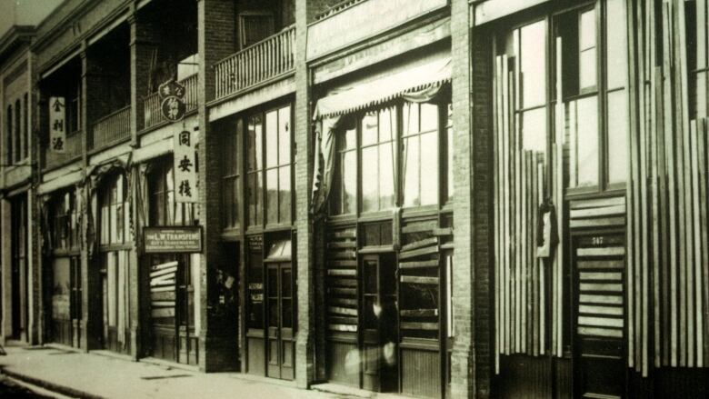 Businesses in the 500-block of Carrall Street in Vancouver have broken windows boarded up, after a 1907 race riot targeting Chinese and Japanese people and businesses tore through the neighbourhood.