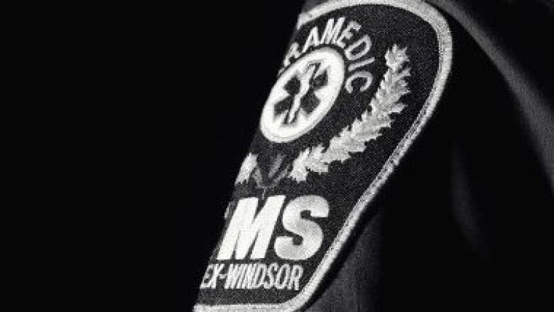 A black and white photo of an Essex-Windsor EMS patch on a uniform