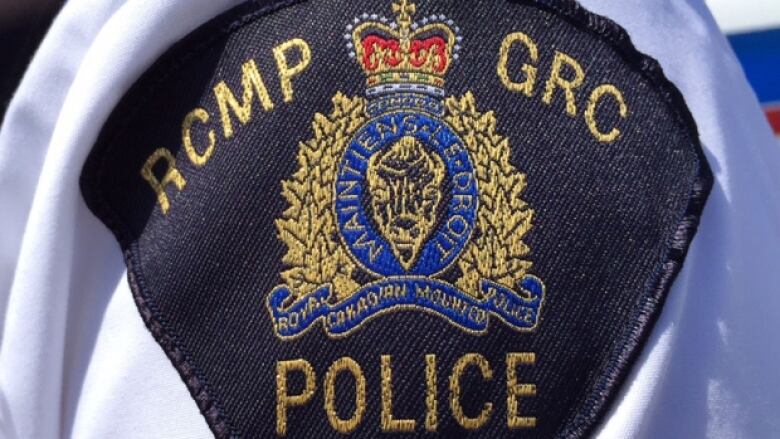 An RCMP badge is shown on an officer's arm.