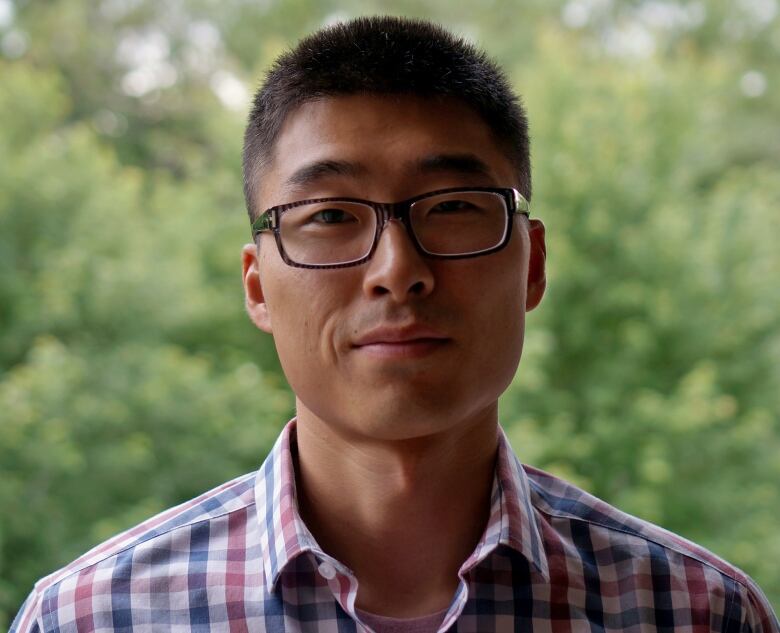 A man smiles at the camera.