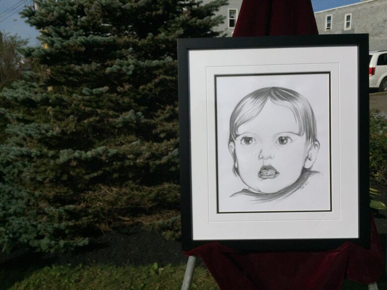 A portrait of a baby girl is shown on a white canvas.