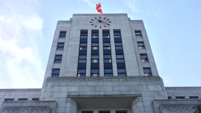 the front side of the building with a big clock face