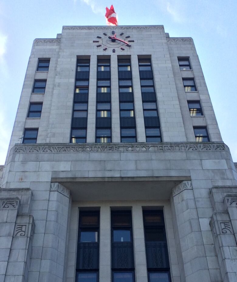 the front side of the building with a big clock face