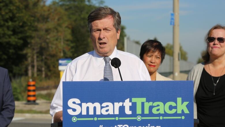  Man in white shirt at podium.