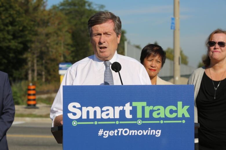  Man in white shirt at podium.