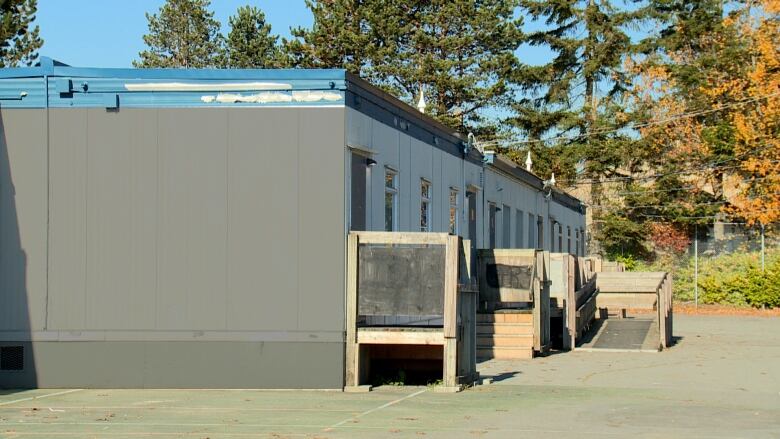 A row of portable classrooms on a school lot.