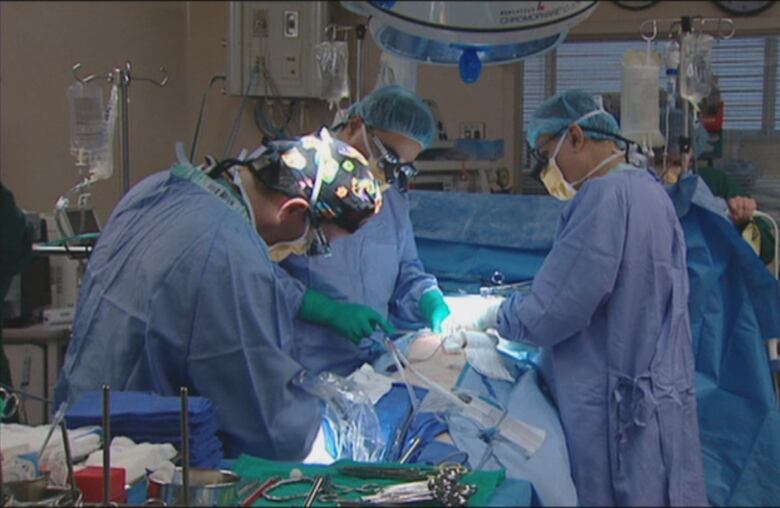 Surgeons performing a surgery.