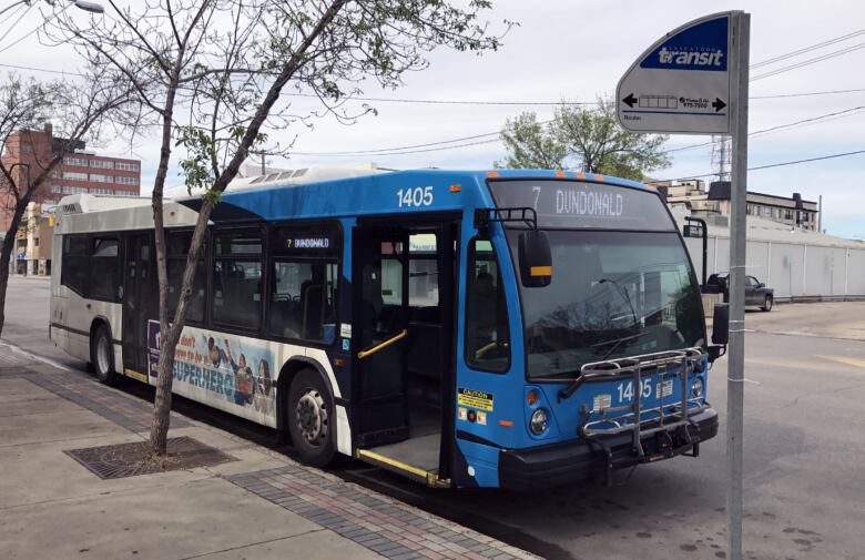 A city bus is parked on a street in saskatoon