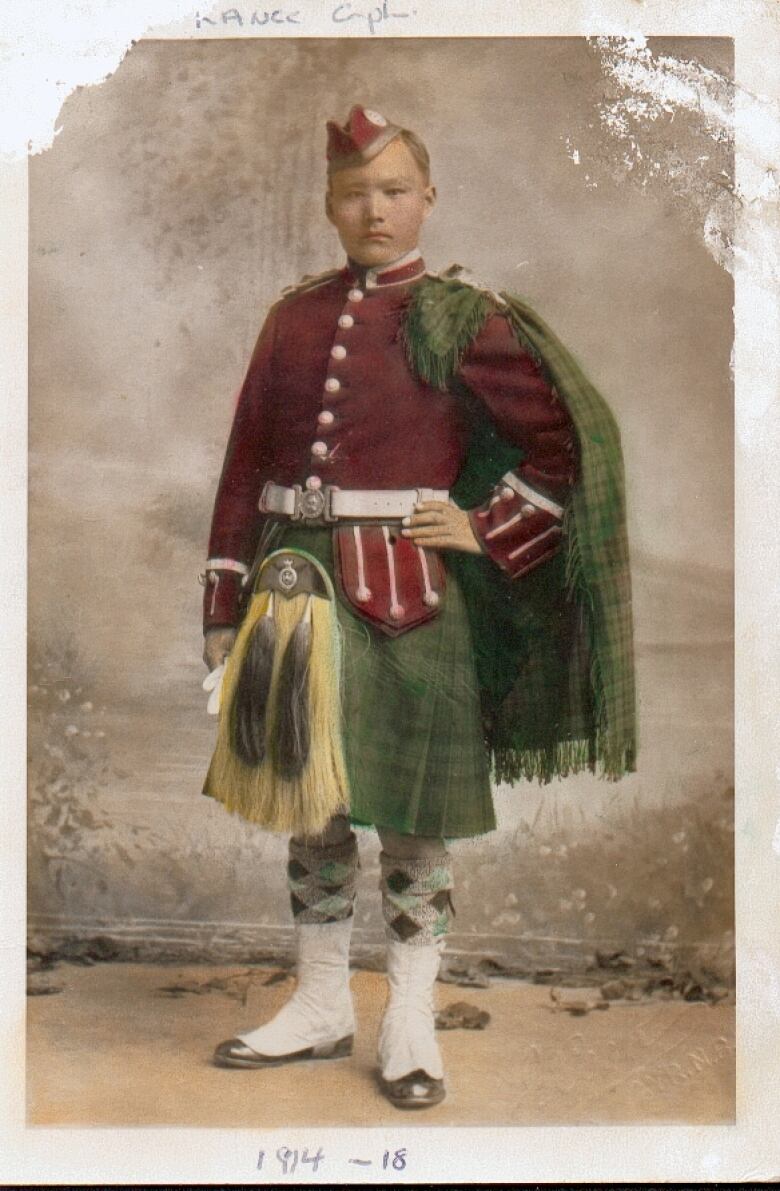 An Indigenous man in military uniform. This is a colourized version of an old black and white photograph.