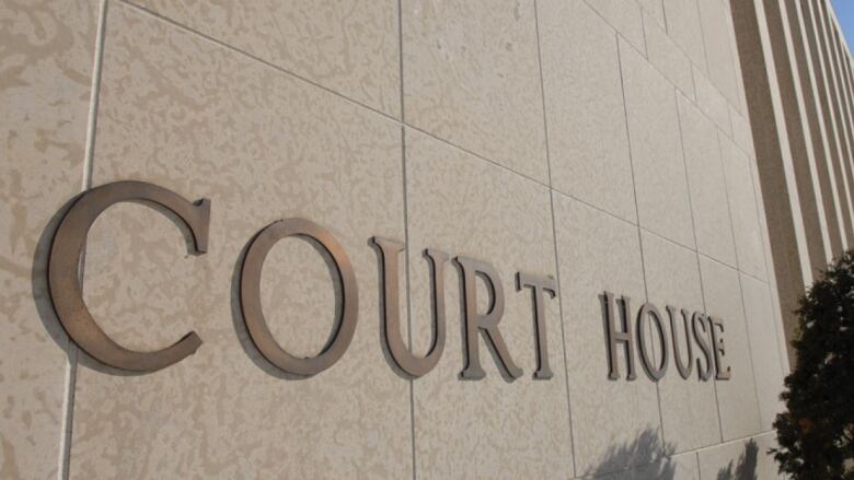 A courthouse in Regina with a sign that says 