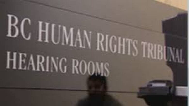 A sign with the words B.C. Human Rights Tribunal.