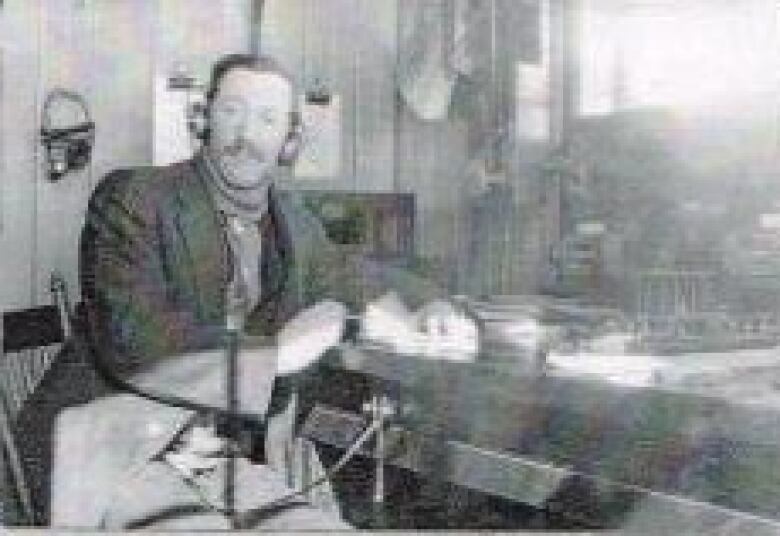 A black and white photo of a man wearing headphones. 