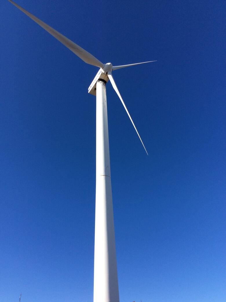 Wind turbine against a blue sky.