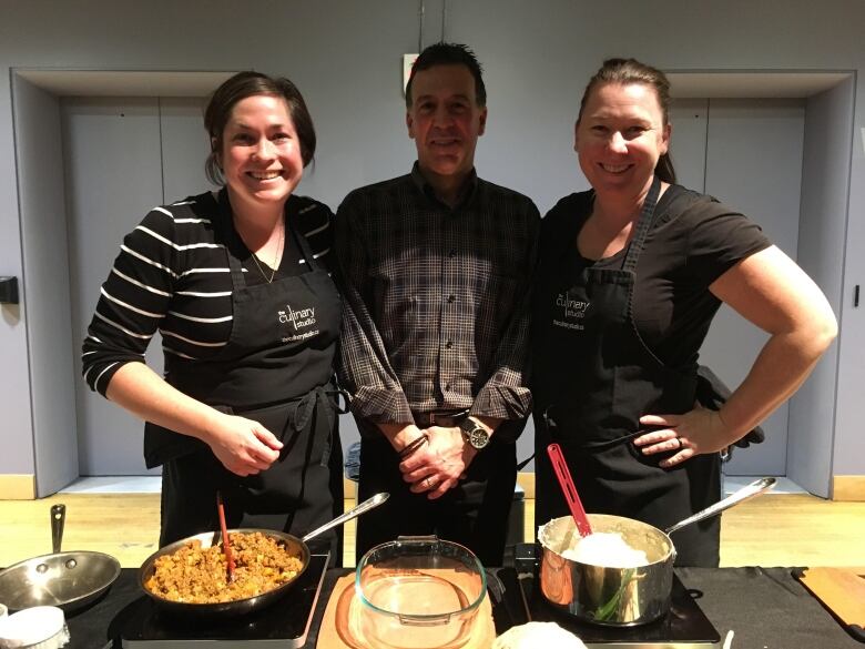 Two female chefs pose with food columnist Andrew Coppolino