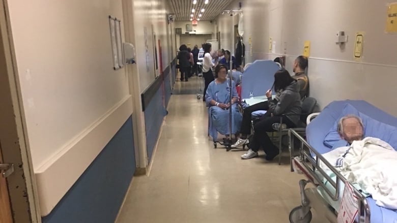 Patients waiting in a hospital hallway.