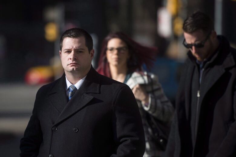 James Forcillo, wearing a black pea coat, walks into court.