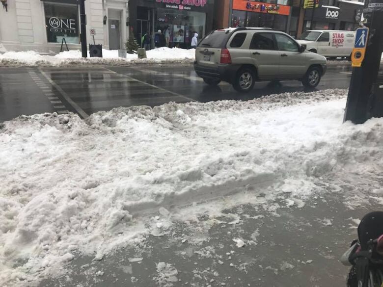 lots of frozen snow on the sidewalk