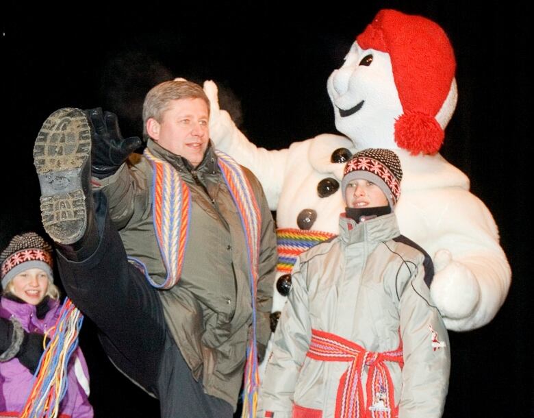 Stephen Harper dances with a mascot.