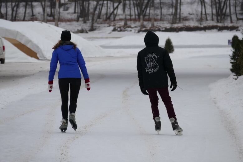 Two people ice skating.