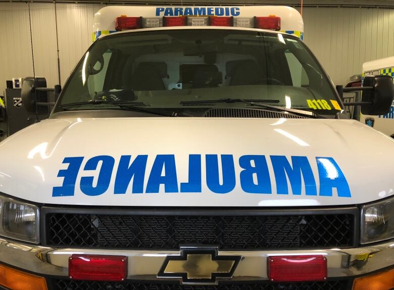 A close up photo of the front of an ambulance showing its sirens and lights.