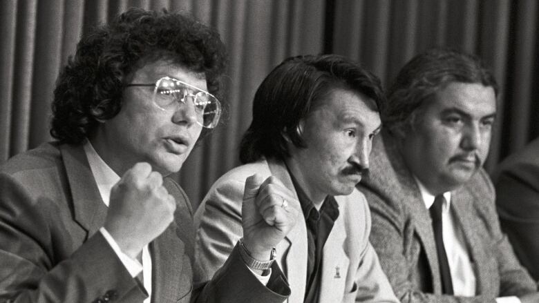 Thee Indigenous leaders at a press conference in a black and white photo.