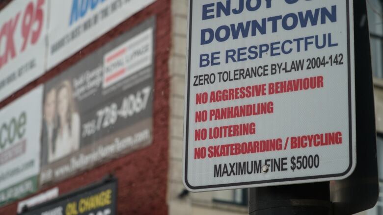 A close-up of a sign advising residents and visitors to be respectful in the downtown area.