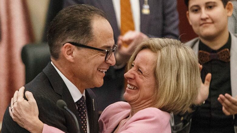 The finance minister and premier embrace after the budget speech in 2018.