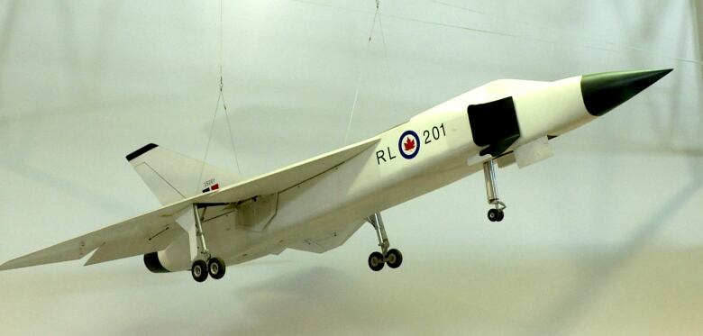 A model of the Avro Arrow hangs by strings from the ceiling. 