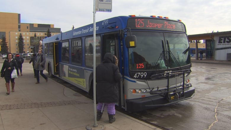 Riders get on and off a bus at the Kingsway transit centre, headed for Jasper Place in west Edmonton. 