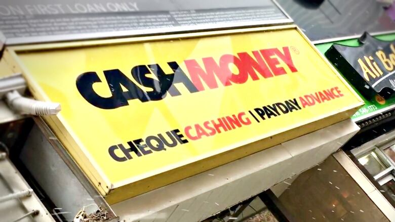 A bright yellow sign at a payday lending facility reads 