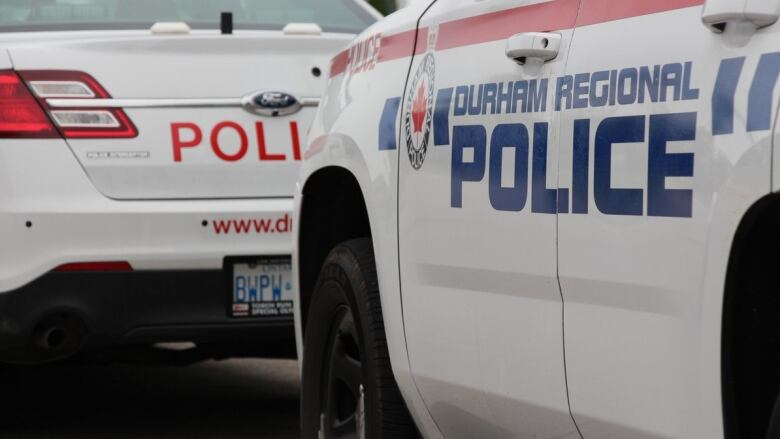 Two Durham Regional Police Service cruisers are shown.