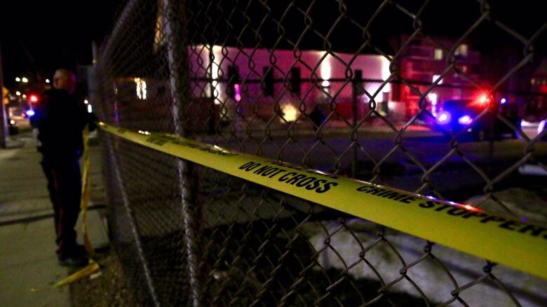 Police tape on a wire fence.