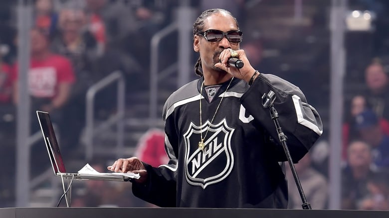 Snoop Dogg wearing an NHL jersey.