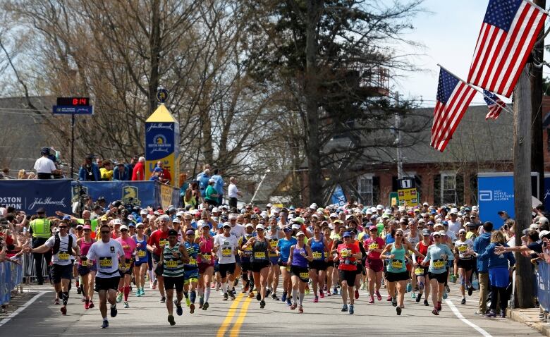 Runners cross the starting line for the 121st running of the Boston Marathon in Hopkinton, Massachusetts, U.S. April 17, 2017.  