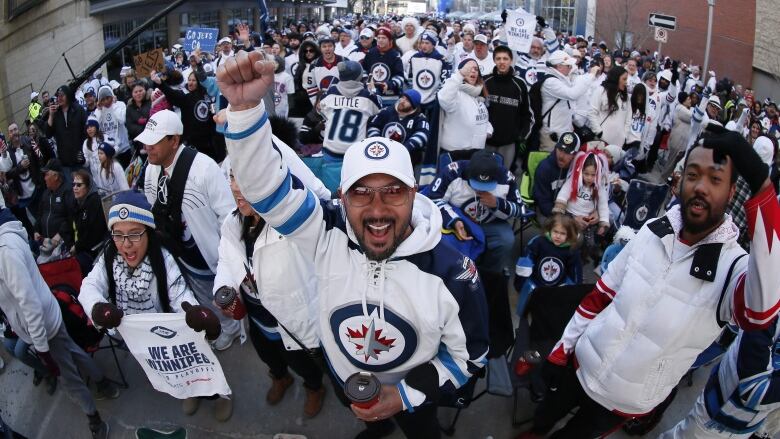 People cheer on a street.