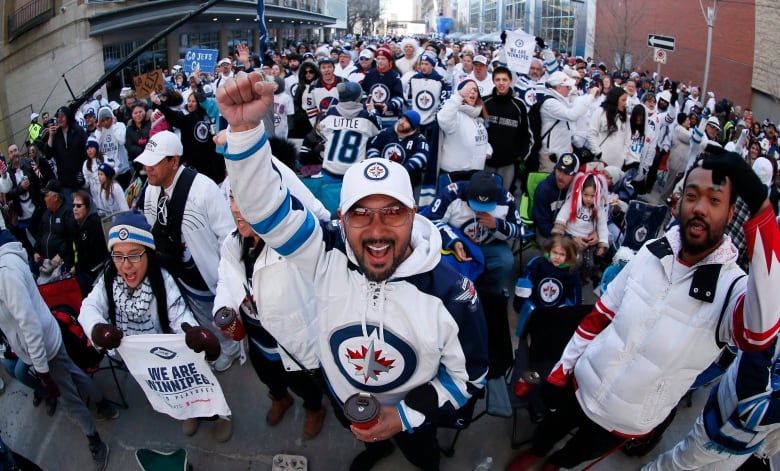 People cheer on a street.