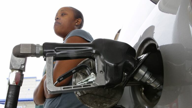 A woman pumps gasoline at a U.S. gas station in this file photo