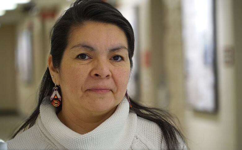 A photograph of an Innu woman in a library at Memorial University. 