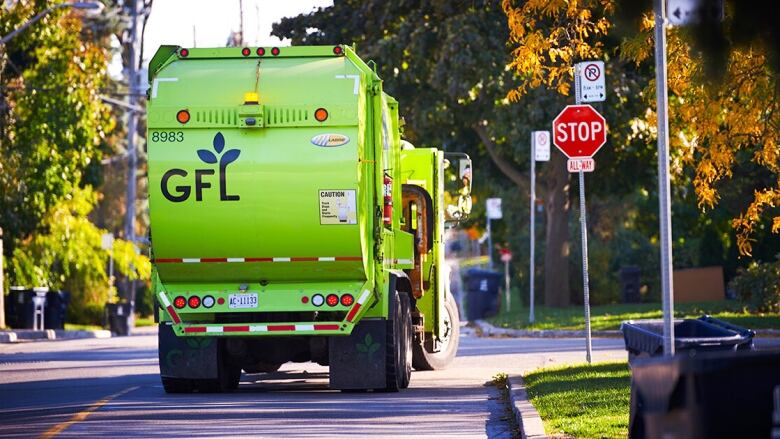 A green truck with the words 'GFL' on it.