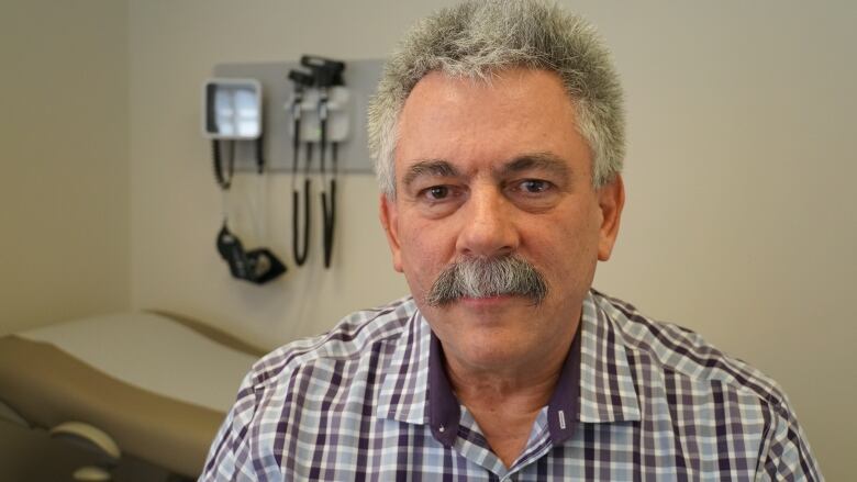 A man in a doctor's examination room.