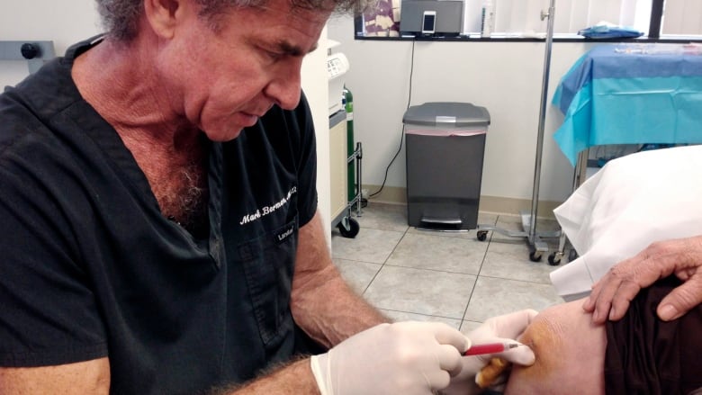 A doctor injects a patient with a solution rich in adult stem cells in this file photo.