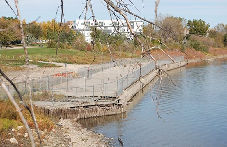 A concrete dock next to a river can be seen in this photo.