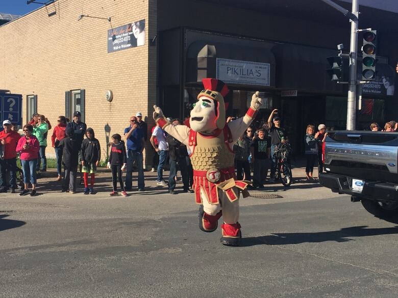 The Titan mascot dances in the streets.