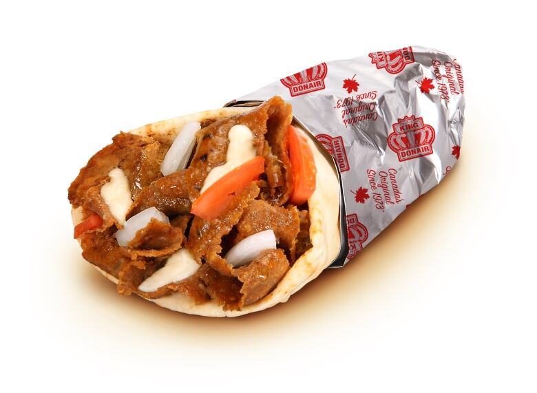 Meat, tomatoes and onion are wrapped in a pita and tin foil.