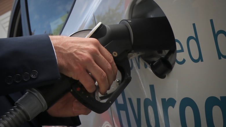 Closeup of a car being refuelled.