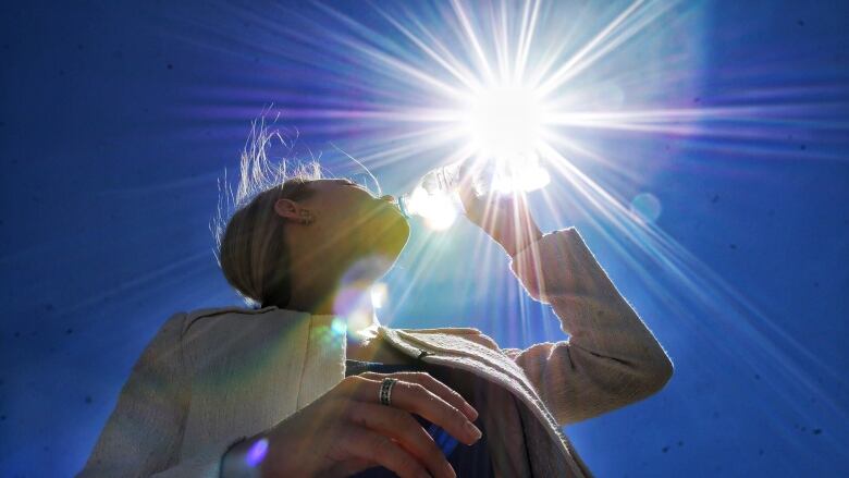 A person drinking water.