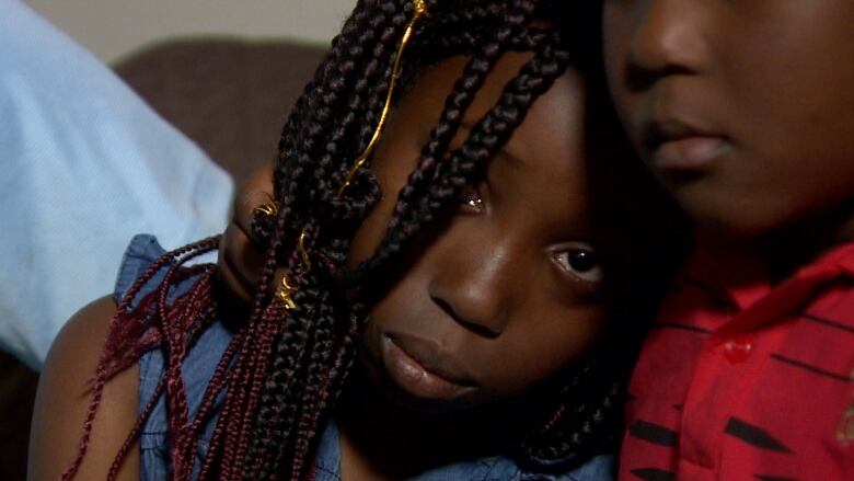 A young boy comforts his older sister after their mother was deported and spent four years away from them.