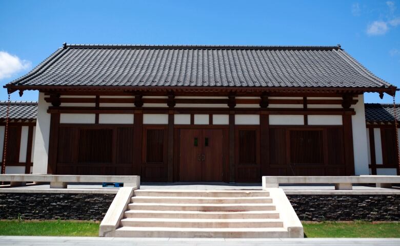 An architect's rendition of a building with a curving pagoda roof. 