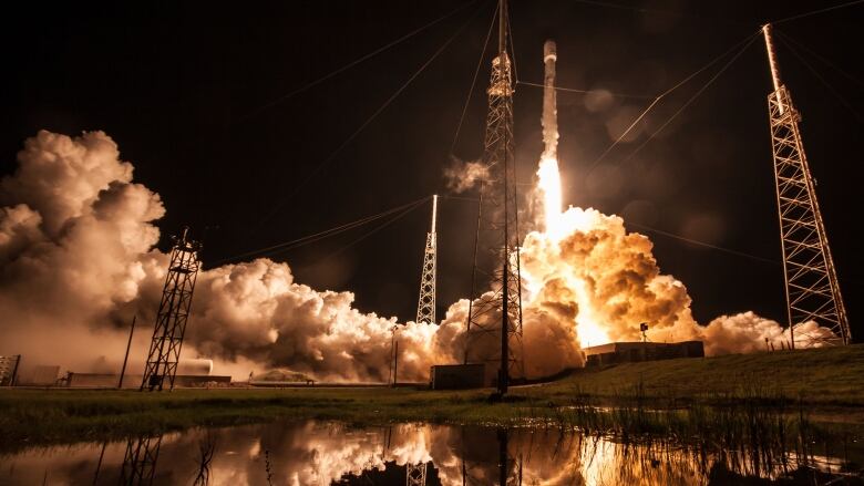 A rocket launches in the dark.