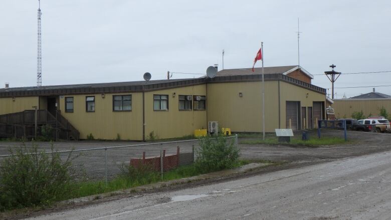 A yellow RCMP building is seen from the outside.